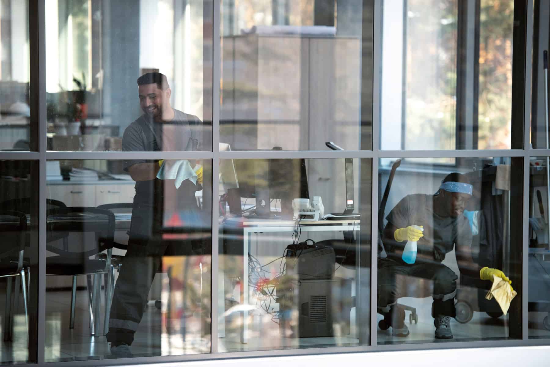 Technician cleaning an interior office window