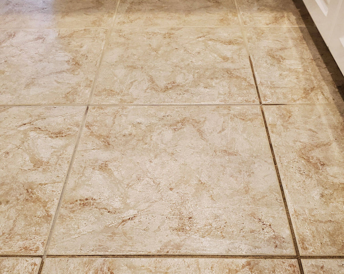 Grout sealing process on tiled floor